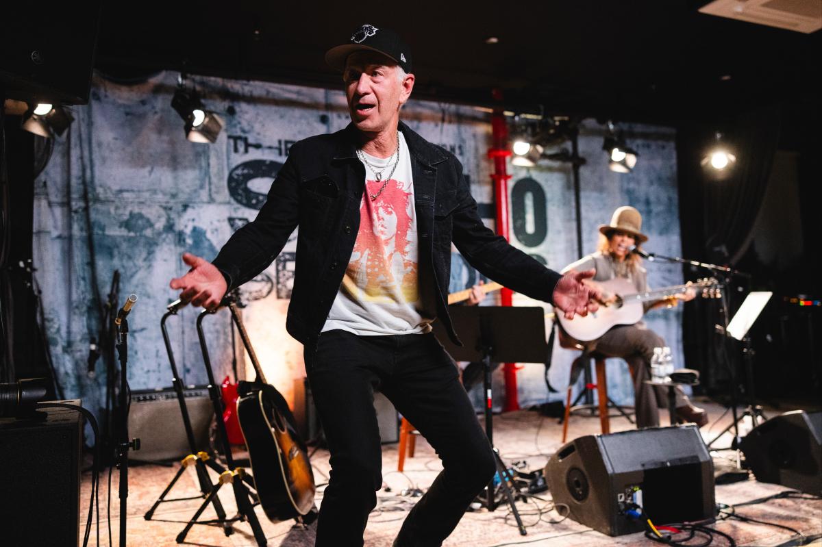 John McEnroe storms the stage during Linda Perry's show