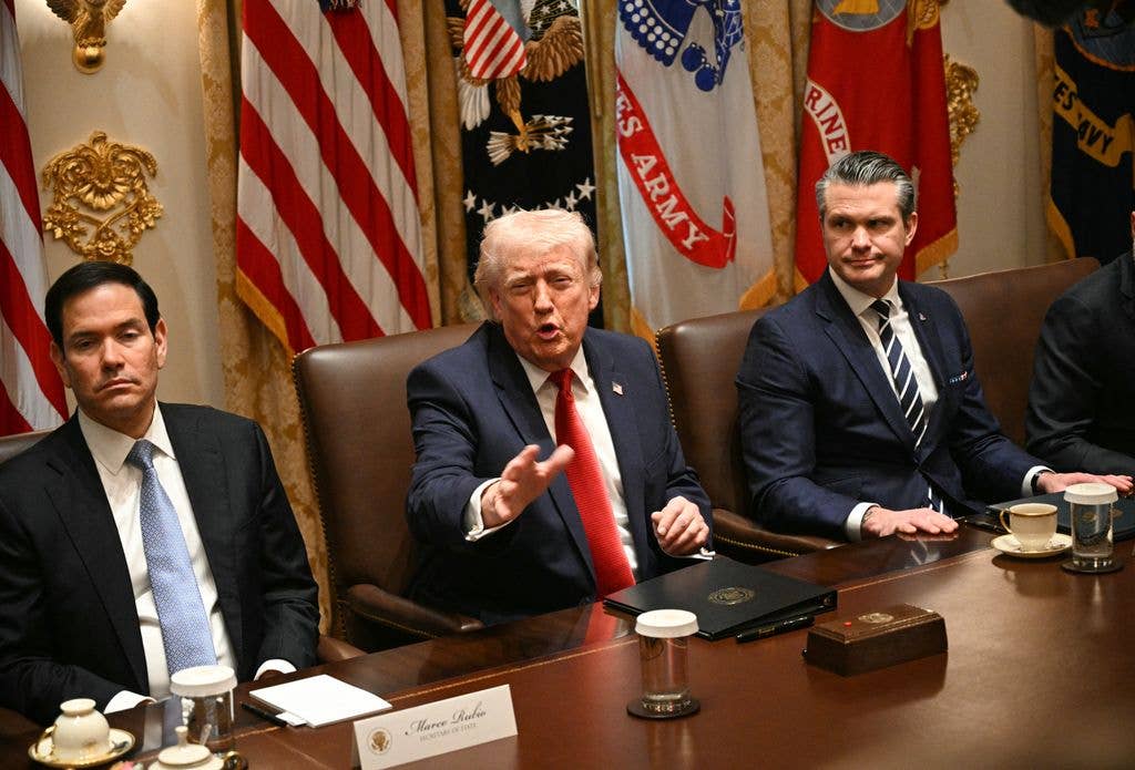 Donald Trump, flanked by Secretary of State Marco Rubio (L) and Defense Secretary Pete Hegseth (R), speaks during a cabinet meeting in the Cabinet Room of the White House in Washington, DC, on March 26, 2026