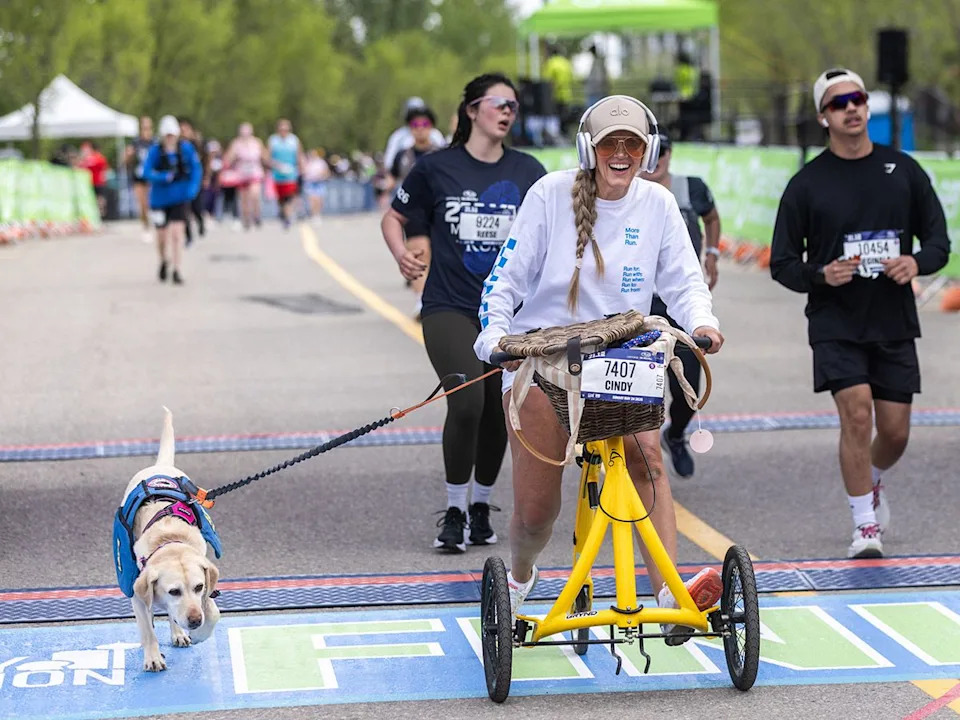 Cindy Luterbach and her service dog Mallee finished the 21.1 km event of the Servus Calgary Marathon on Sunday, May 24, 2026 on an Alinker ‘walking bike’.