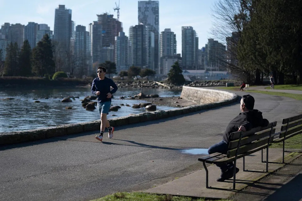 People running along the seawall during a period of warm weather in Vancouver, B.C., on Thursday, February 5, 2026.