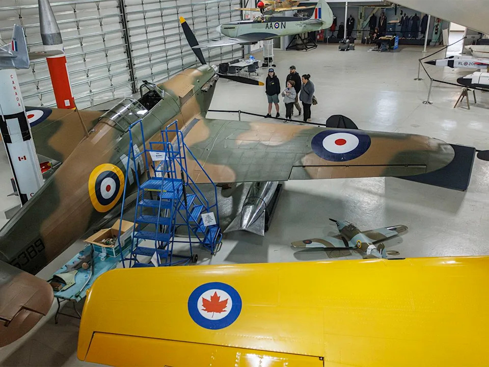 Visitors check out a Hawker Hurricane fighter among the many planes on display at The Hangar Flight Museum in Calgary on Sunday, Nov. 16, 2025.