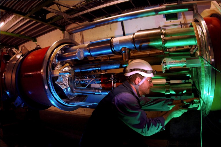 An engineer working on magnets in an open section of the Large Hadron Collider.
