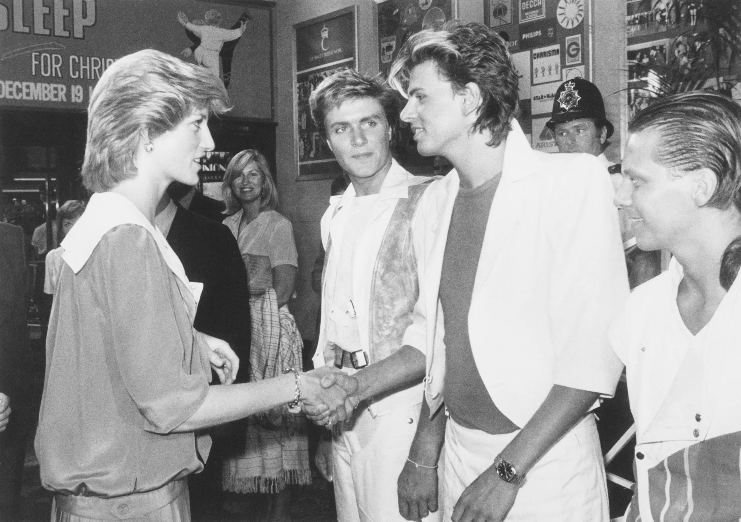Princess Diana shakes hands with John Taylor of Duran Duran as Simon Le Bon and Andy Taylor look on at the Prince's Trust Rock Gala.