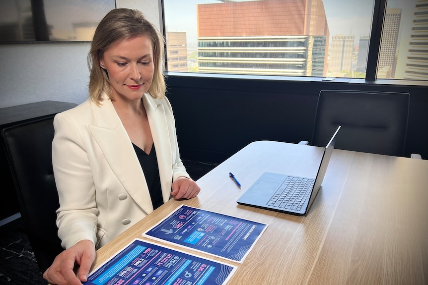 CEO of CALI, Christine Cupitt sits at her desk with laptop open