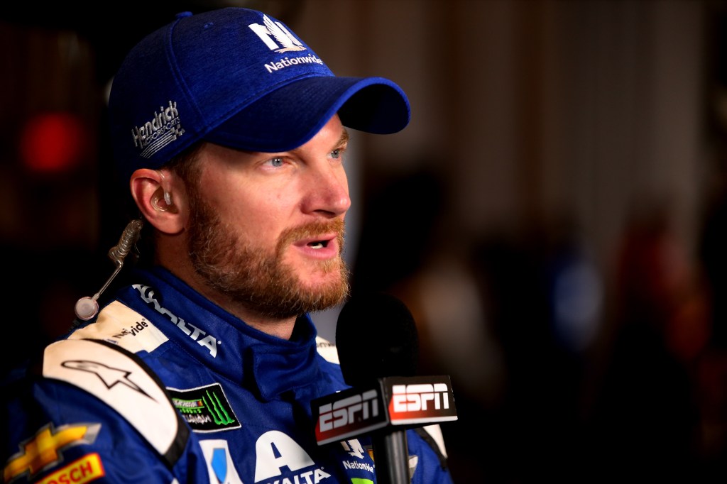 Dale Earnhardt Jr. speaking to media with an ESPN microphone.