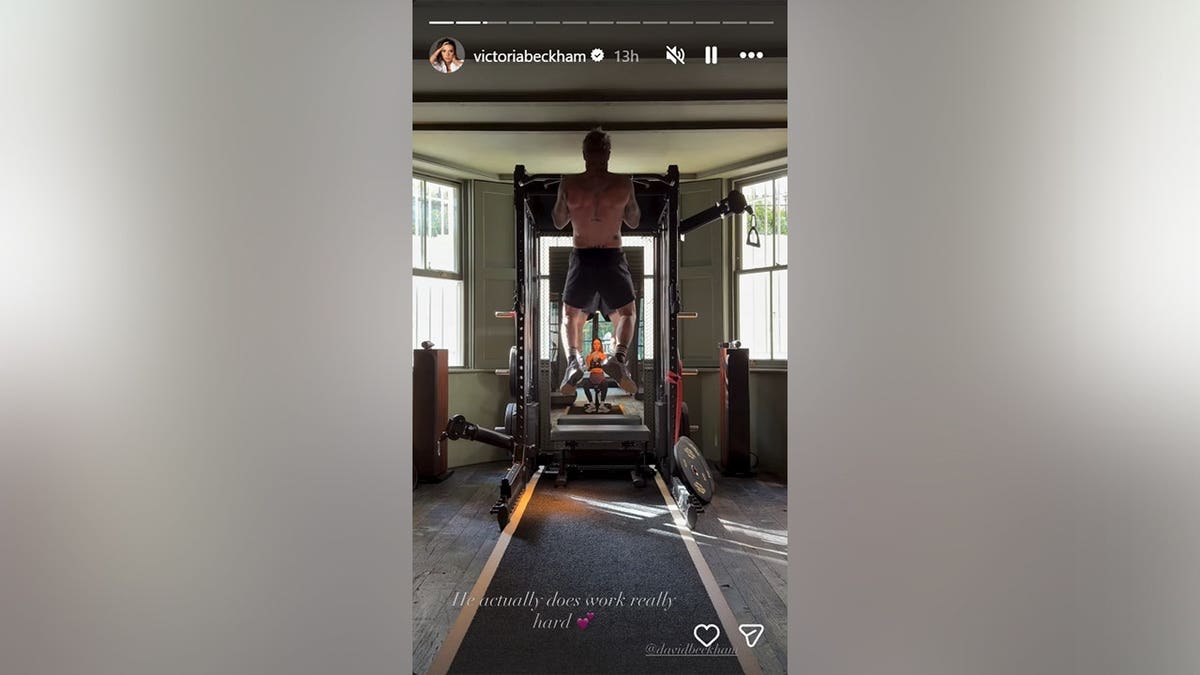 A picture of David Beckham doing pull-ups from the back.