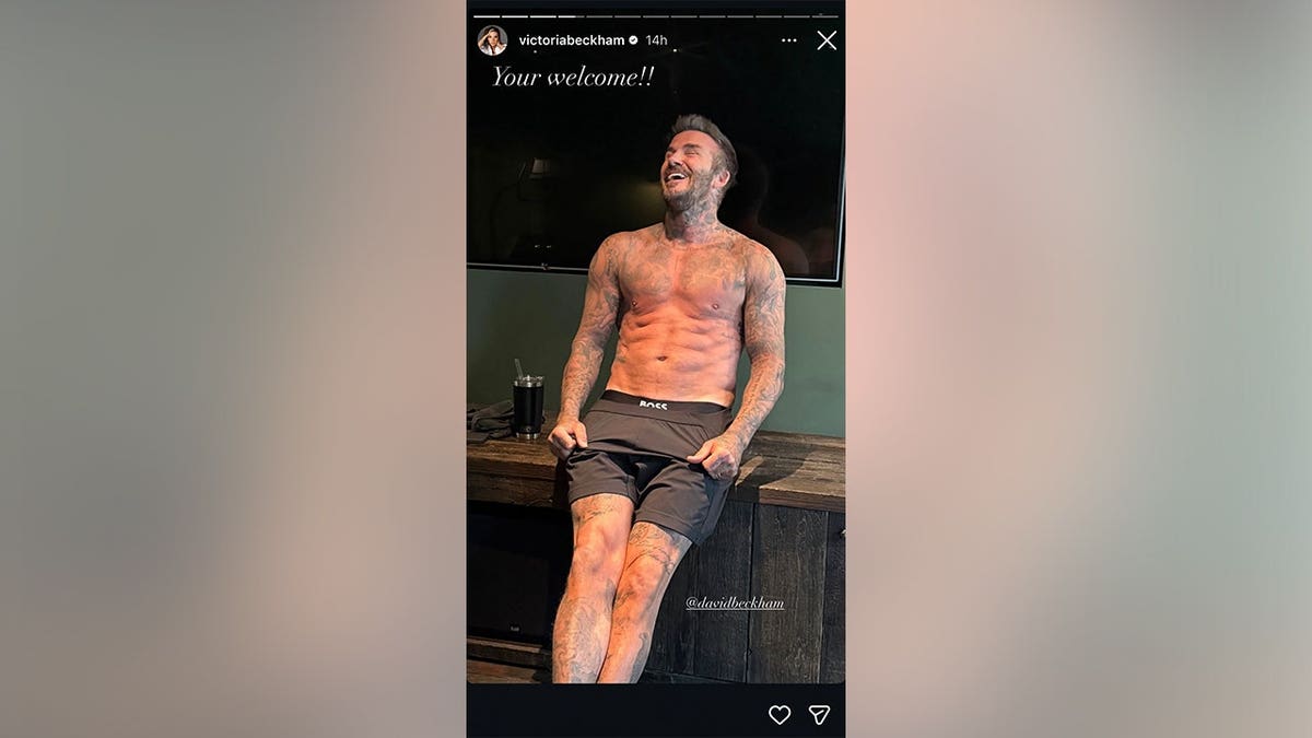 A picture of David Beckham smiling while shirtless in the gym.