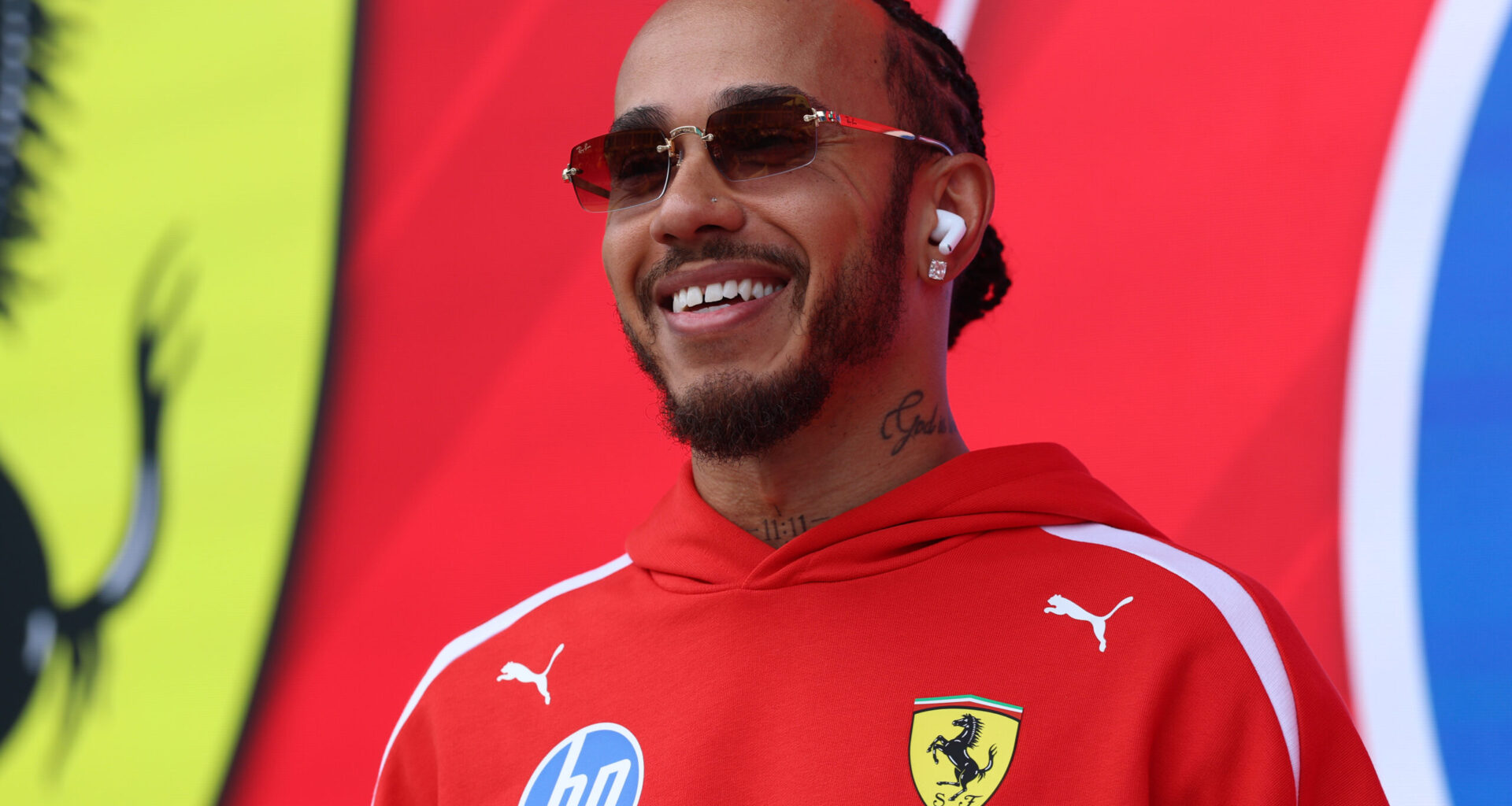 Ferrari driver Lewis Hamilton (44) smiling in Ferrari hoodie