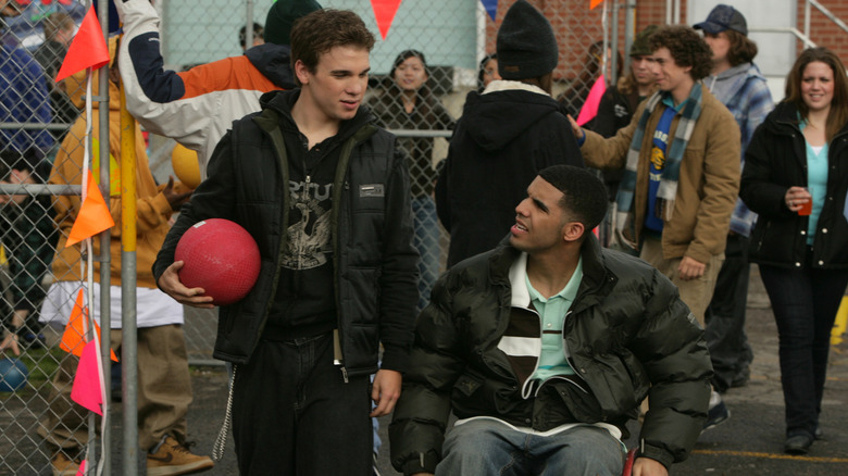 Spinner (Shane Kippel) and Jimmy (Drake) talking together on Degrassi: The Next Generation