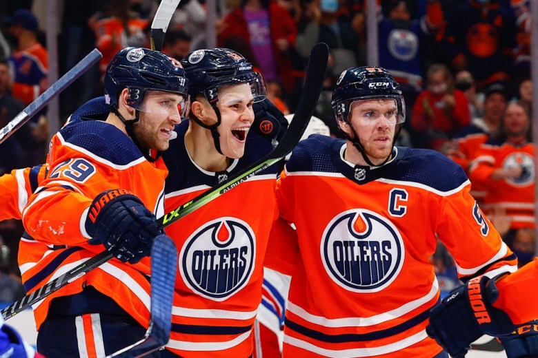 Edmonton Oilers Right Wing Jesse Puljujarvi (13), Edmonton Oilers Center Connor McDavid (97) and Edmonton Oilers Left Wing Leon Draisaitl (29) celebrate a power play goal in the third period during the Edmonton Oilers game versus the New York Rangers on November 5, 2021 at Rogers Place in Edmonton, AB