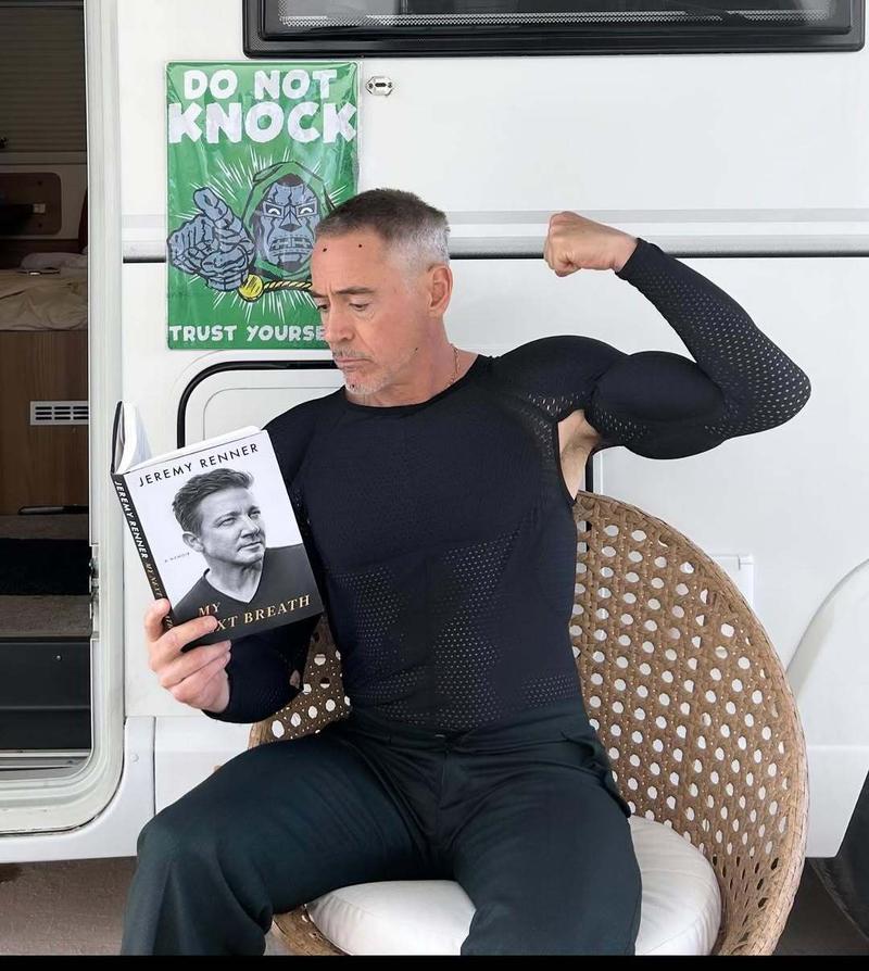 Robert Downey Jr. flexing his muscles.