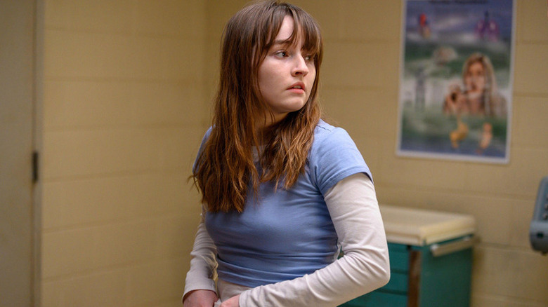 Betsy, seated and looking on