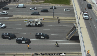 A traffic camera photo shows the box from a dump truck resting against an overpass on Hwy 403 after the truck struck the overpass on May 15, 2026. Credit: Ontario 511