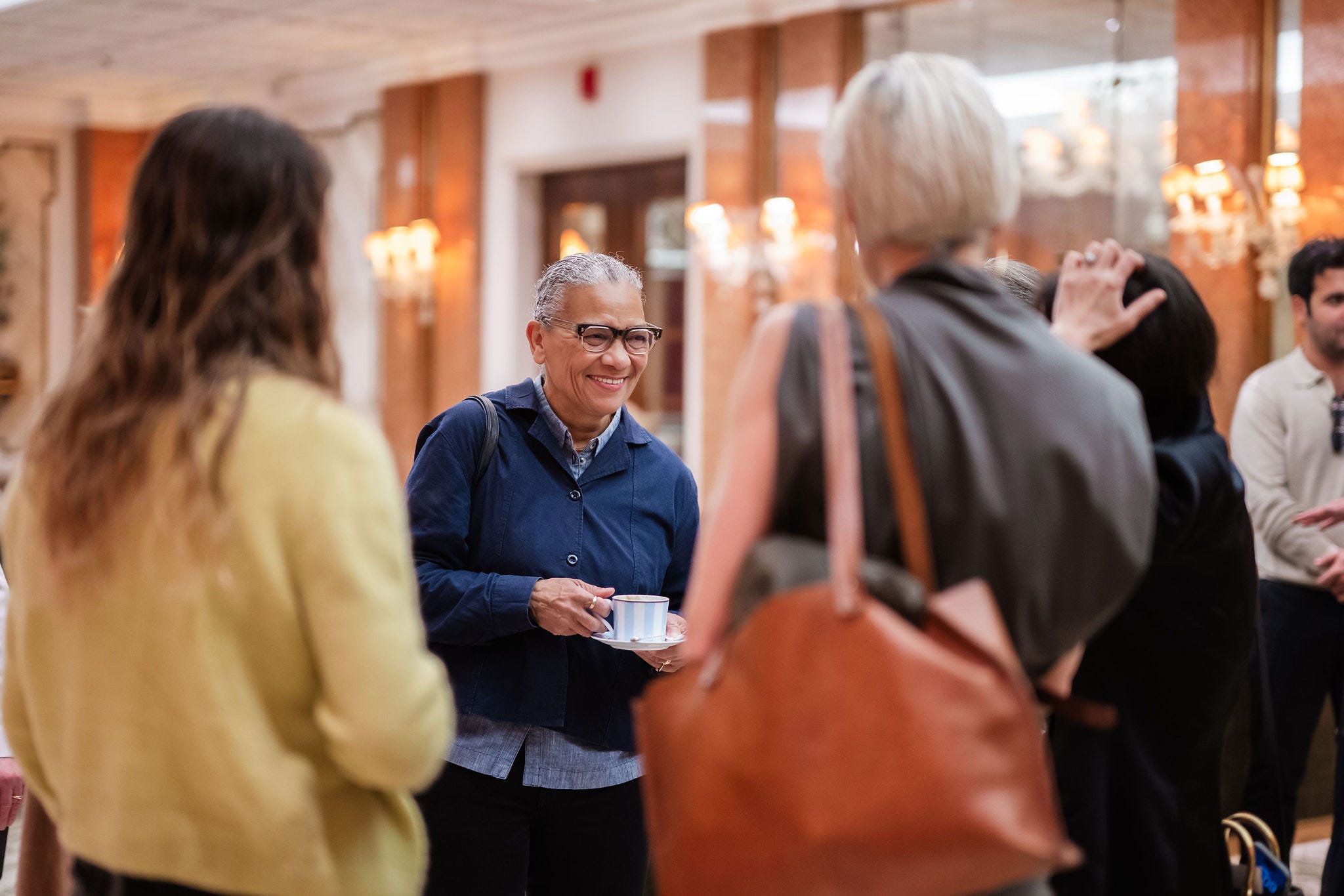 Group of people interacting in a social setting Group of people interacting in a social setting