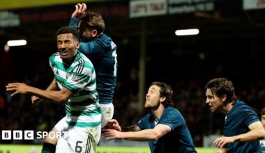 Referee John Beaton is surrounded by Celtic players