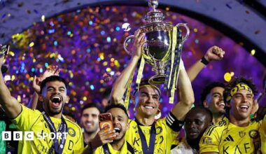 Cristiano Ronaldo of Al-Nassr lifts the Saudi Pro League trophy as he stands with team-mates following the match against Damac