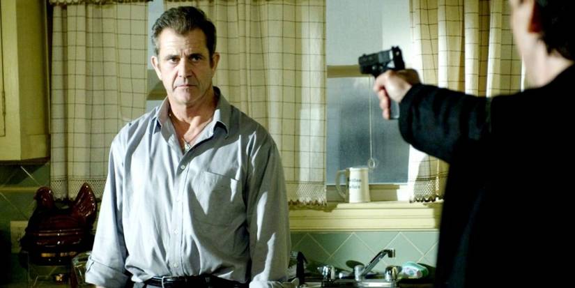 Unknown man points gun at Thomas Craven (Mel Gibson) in Edge of Darkness
