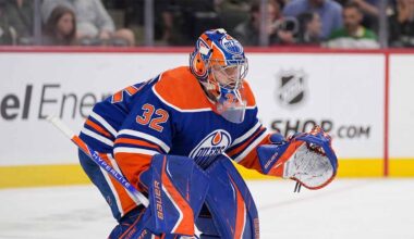 A conceptual photograph visualizing goaltender Filip Gustavsson wearing a royal blue and orange Edmonton Oilers uniform with number 32, representing the rumored NHL trade from the Minnesota Wild.