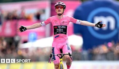 Jonas Vingegaard raises his arms as he crosses the finish line