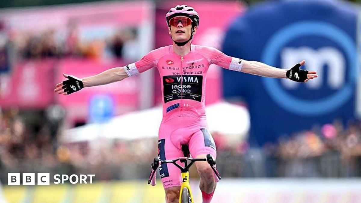 Jonas Vingegaard raises his arms as he crosses the finish line