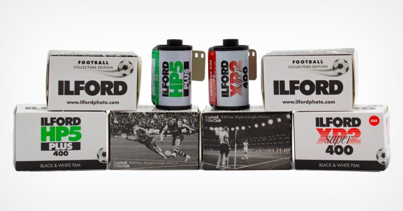 Six boxes and two rolls of Ilford black and white film, labeled as football collectors edition, are arranged in two rows. The boxes feature vintage football match photos and different Ilford film types.