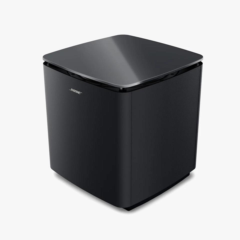 Black Bose subwoofer speaker with a glossy top panel and fabric-covered sides.