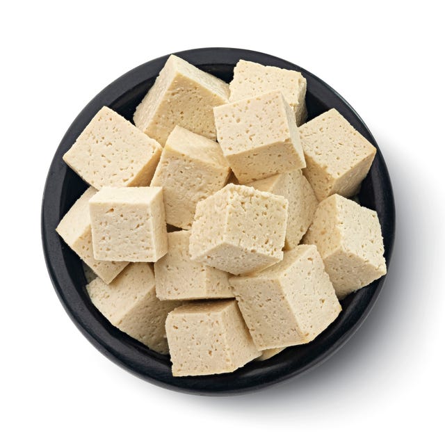Tofu cheese cubes isolated on white background, top view tofu cheese cubes in black bowl isolated on white background with clipping path, top view