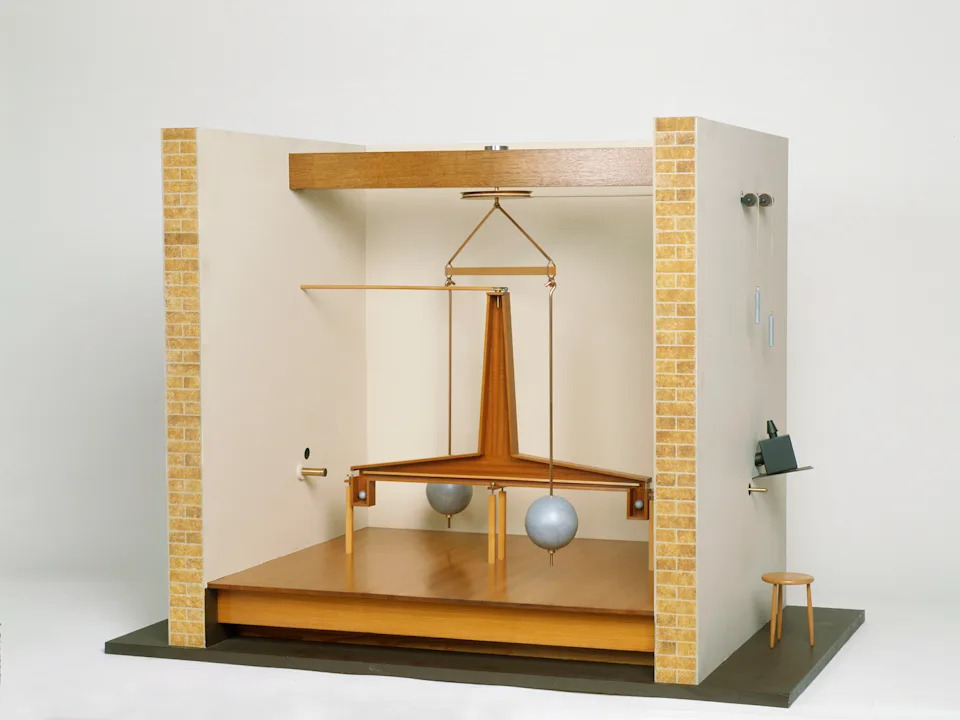 a torsion balance to measure the gravitational force between two large masses