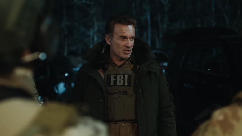 Jess LaCroix in FBI vest, speaking outside