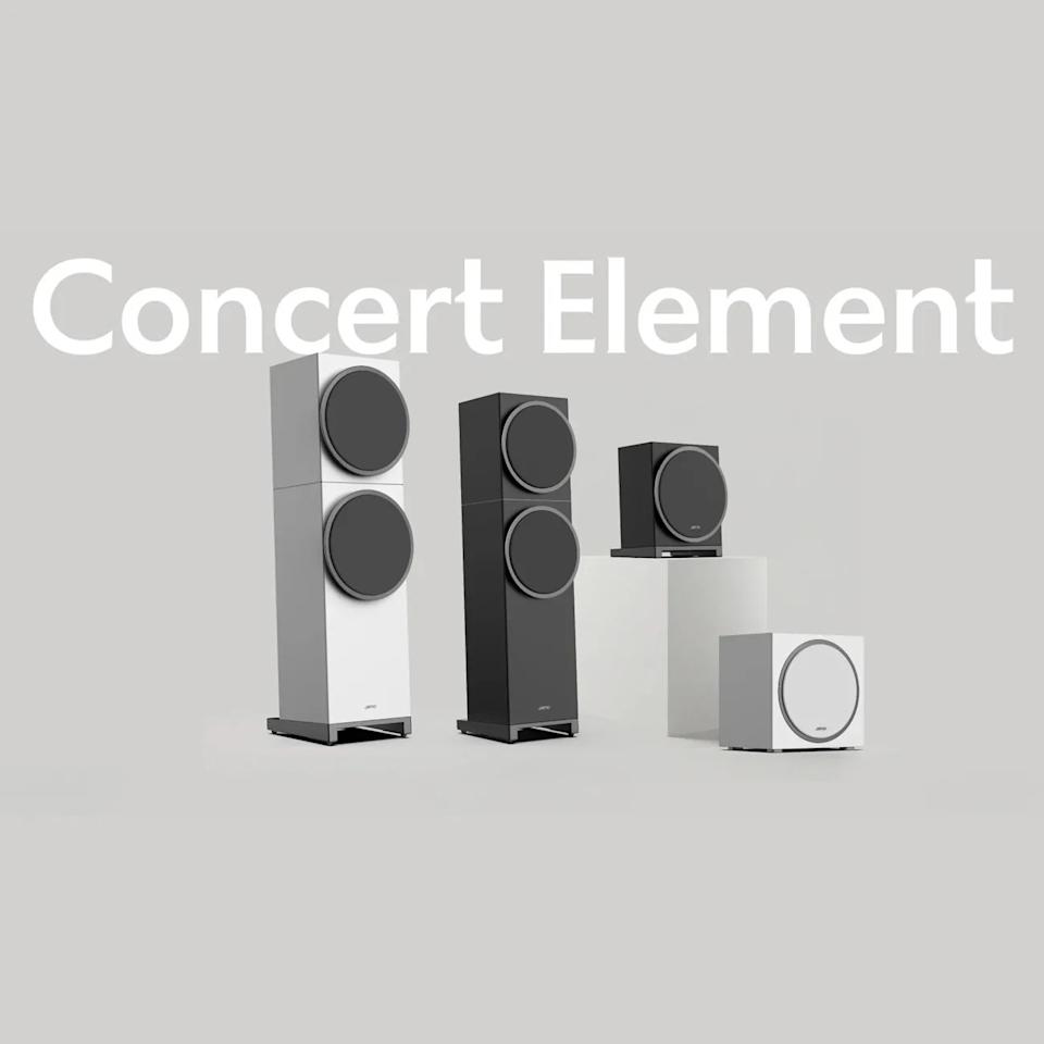 Four Jamo Concert Element speakers in black and white, including two tall floor-standing models and two smaller subwoofers, on a gray background.