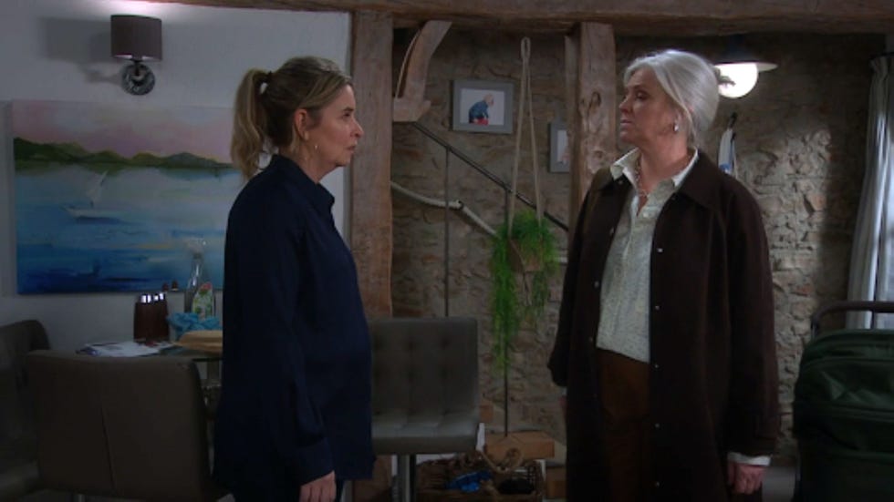 emmerdale charity dr todd two women standing in a room with rustic decor