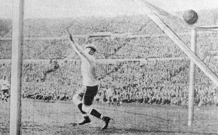 A ball nestles in the top of a goal.