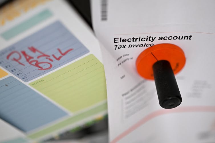 An electricity bill on a fridge door