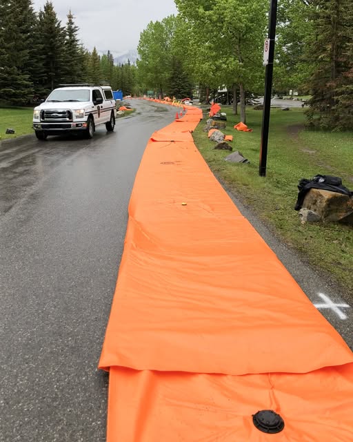 The town of Banff readies for the possibility of flooding by setting up temporary flood barriers.