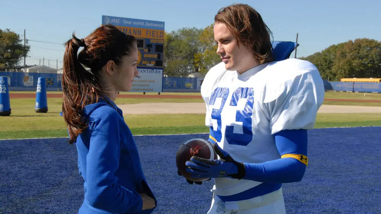 Lyla and Riggins talking on the field on Friday Night Lights