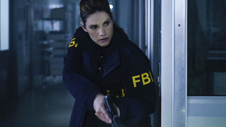 Missy Peregrym as special agent Maggie Bell, wearing her blue uniform FBI jacket with 