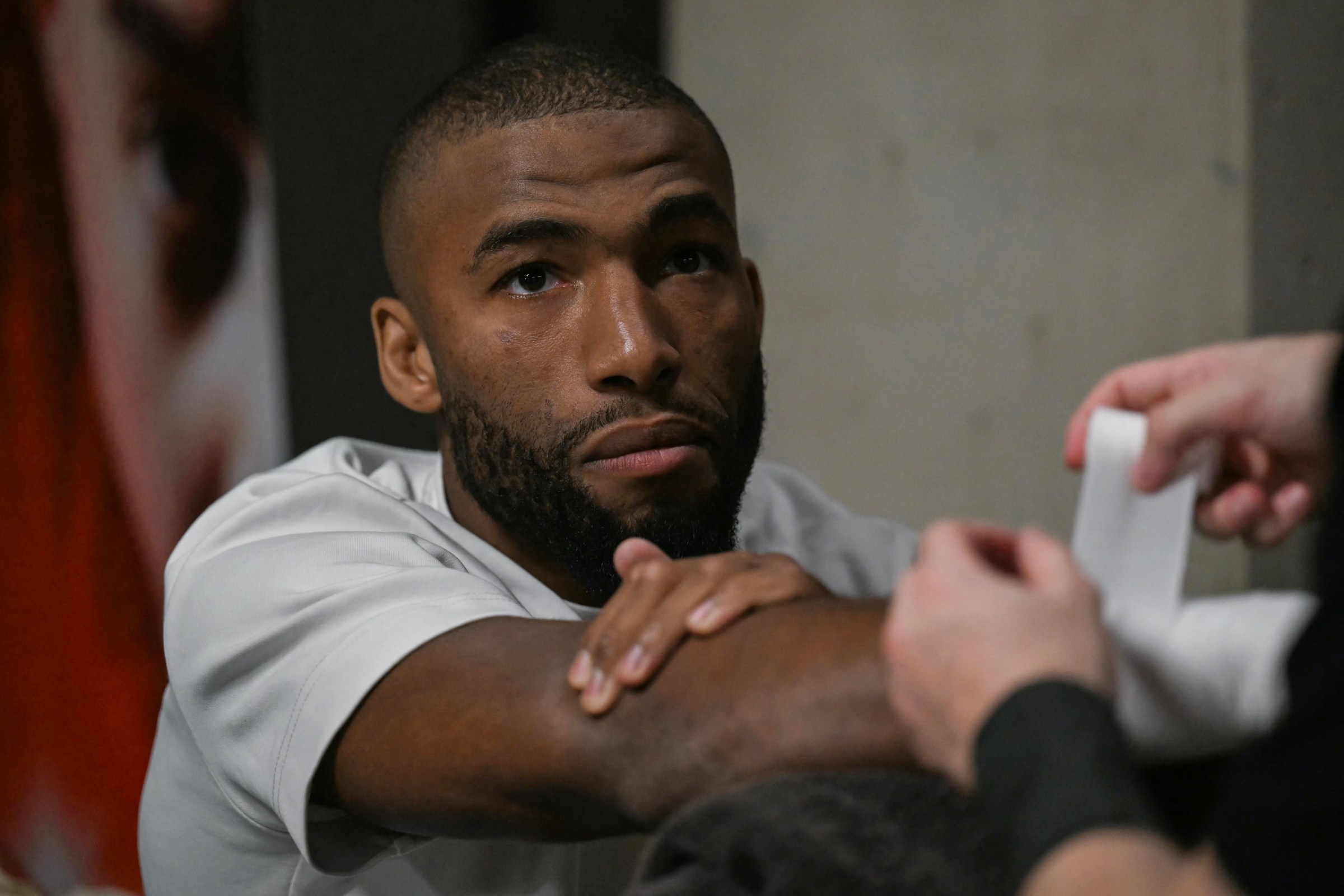 France’s Salahdine Parnasse, two-time KSw champion, has his hands wrapped backstage before his English boxing duel fight against France’s Franck Petitjean (not pictured), former European super-lightweight champion, at the Adidas Arena in Paris on October 4, 2025. (Photo by Anna KURTH / AFP via Getty Images)