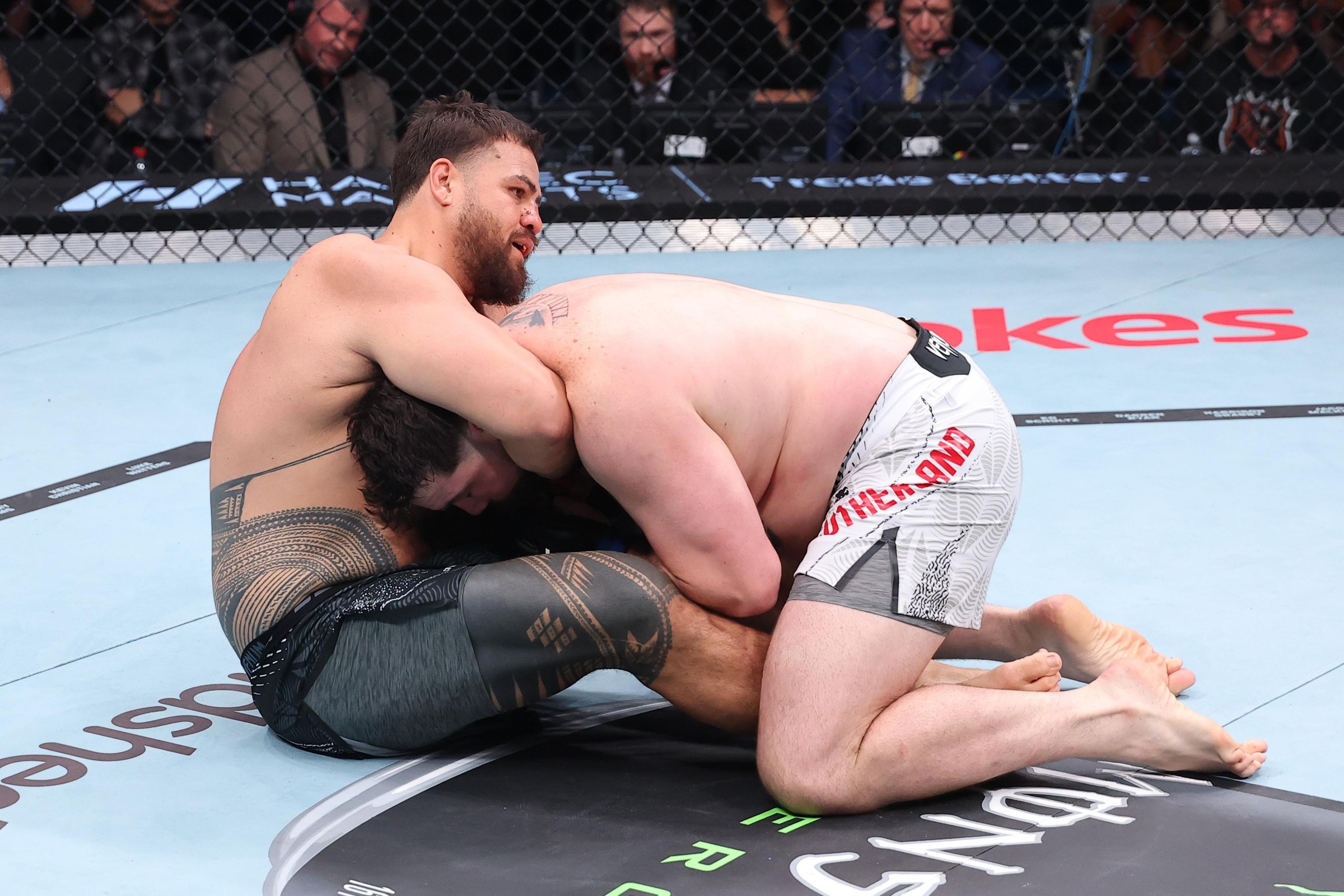 PERTH, AUSTRALIA - MAY 02: (R-L) Louie Sutherland of England takes down Tai Tuivasa of Australia in a heavyweight fight during the UFC Fight Night event at RAC Arena on May 02, 2026 in Perth, Australia. (Photo by Ed Mulholland/Zuffa LLC)