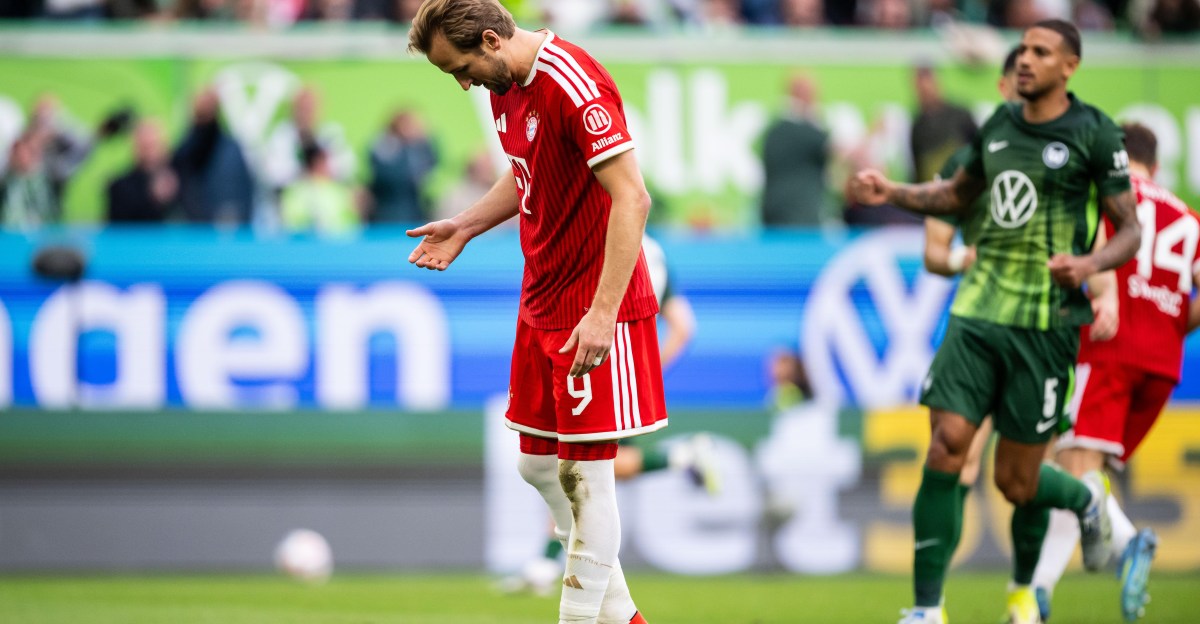 A Wolfsburg player tampers with the penalty spot before Harry Kane miss