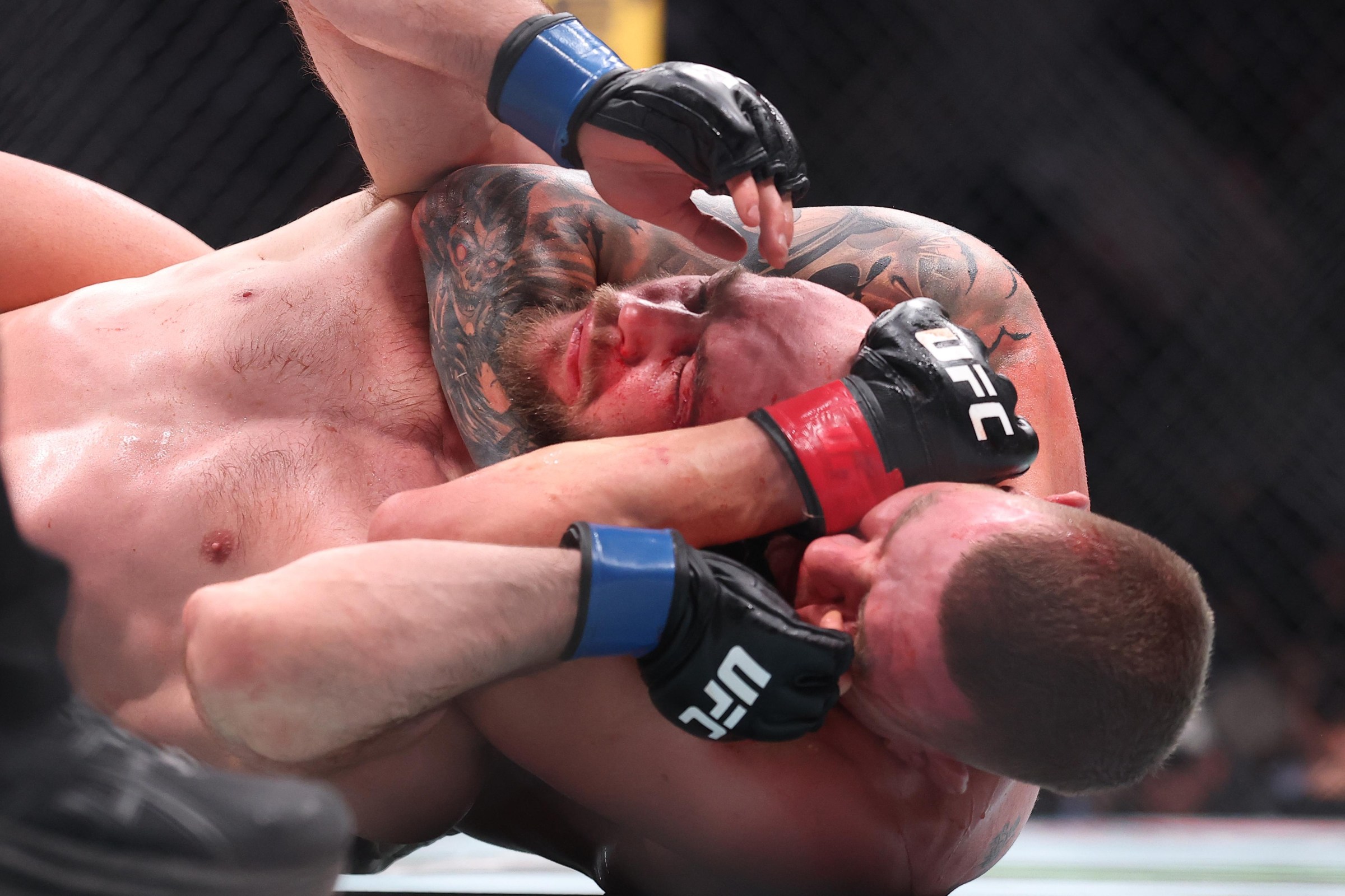 NEWARK, NEW JERSEY - MAY 09: Grant Dawson secures a rear choke submission against Mateusz Rebecki of Poland in a lightweight fight during the UFC 328 event at Prudential Center on May 09, 2026 in Newark, New Jersey. (Photo by Ed Mulholland/Zuffa LLC)
