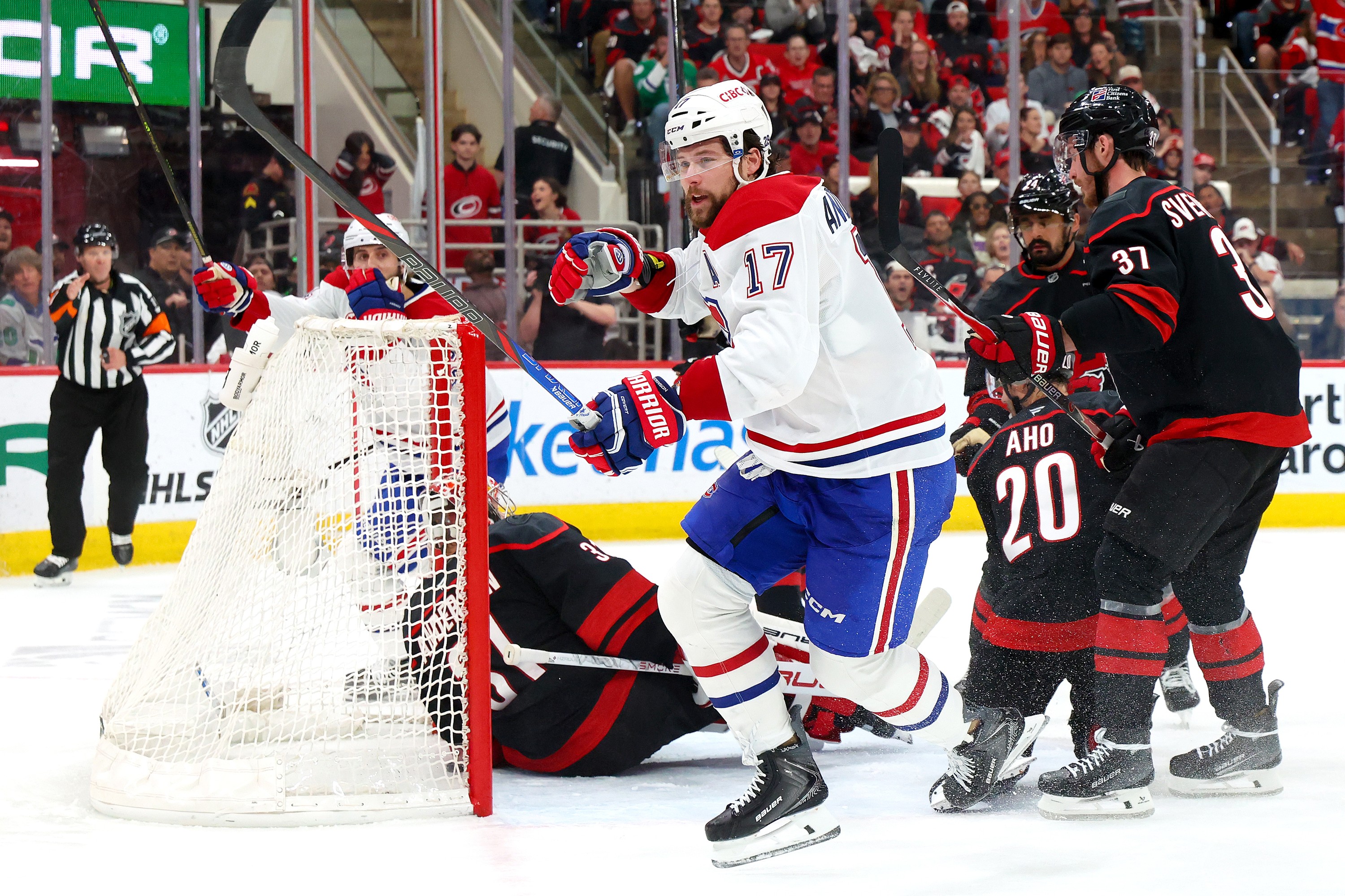 Hockey player celebrates after scoring a goal. 