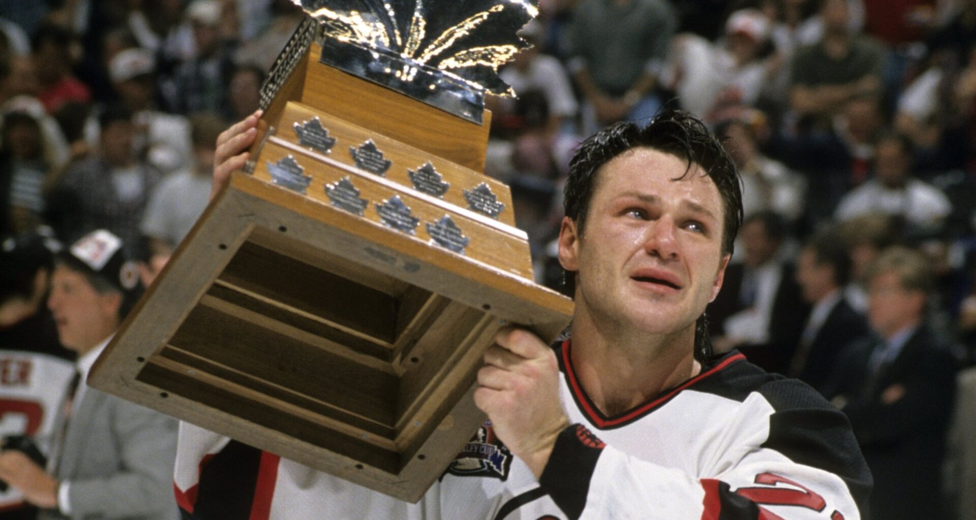 Claude Lemieux in a Devils jersey with the Conn Smythe trophy.