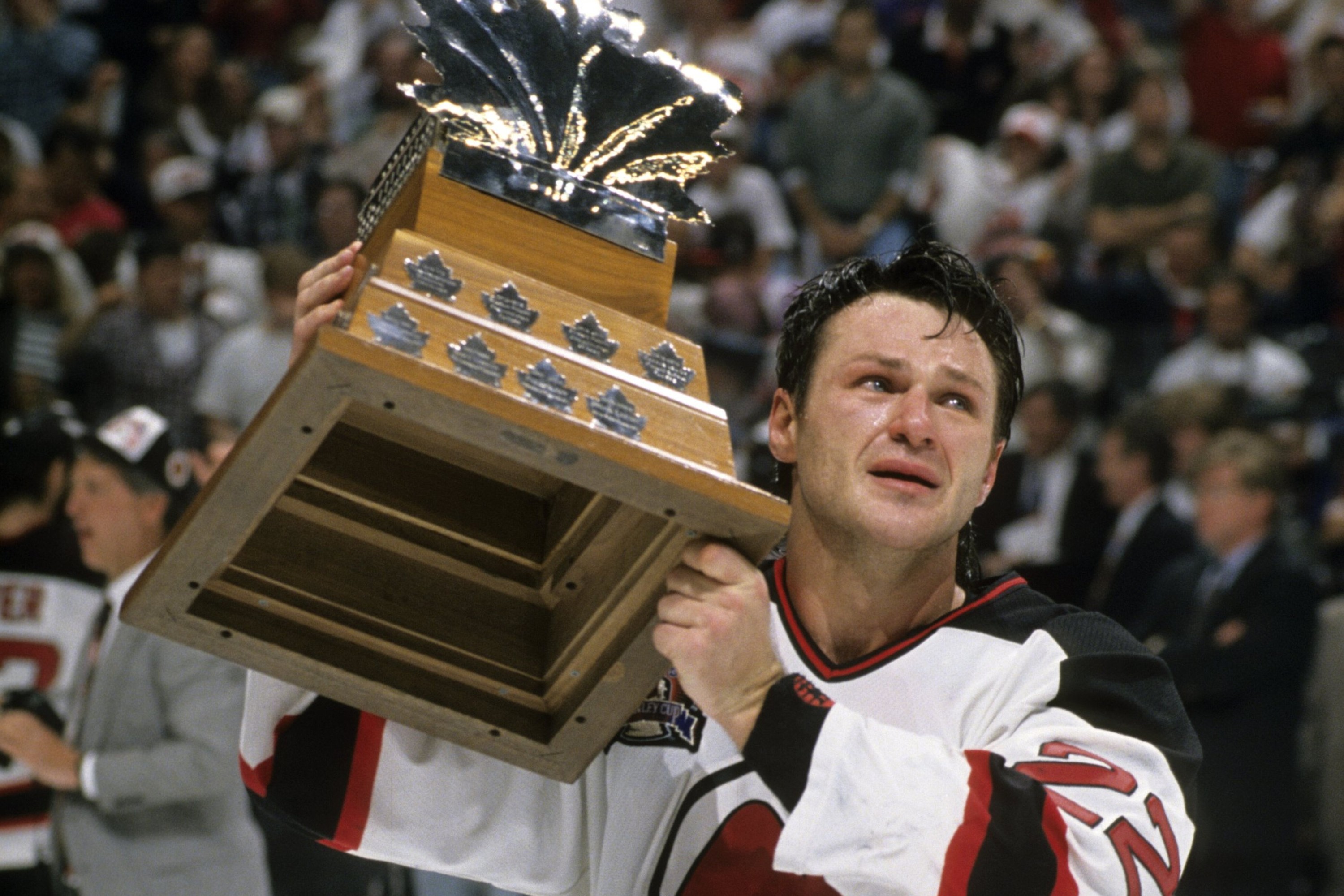 Claude Lemieux in a Devils jersey with the Conn Smythe trophy.