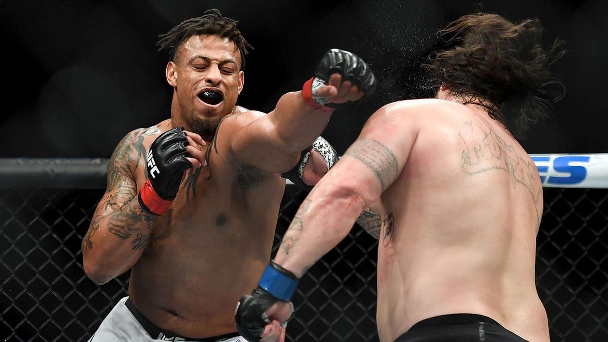 Greg Hardy in red fighting Ben Sosoli in blue during UFC Fight Night at TD Garden