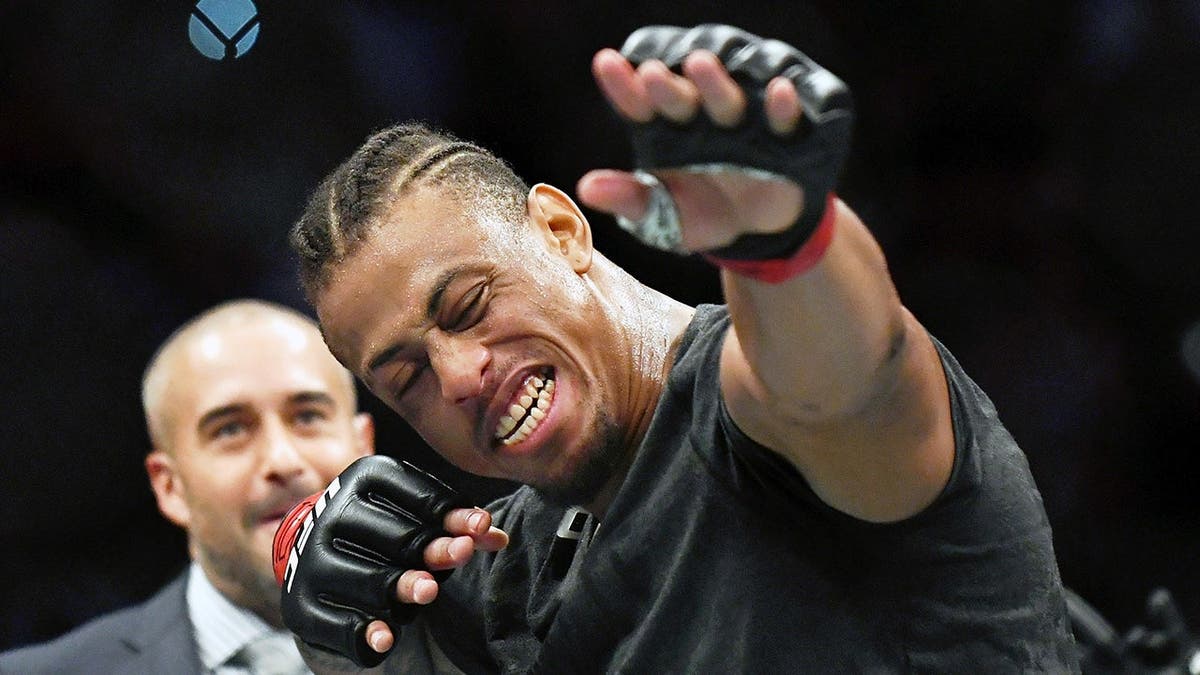 Greg Hardy wearing red gloves celebrating after UFC fight in San Antonio