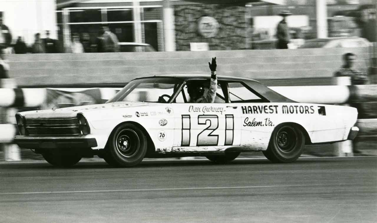Dan Gurney wheeling the #121 Wood Brothers Ford to one of his many NASCAR Cup race wins at Riverside, CA