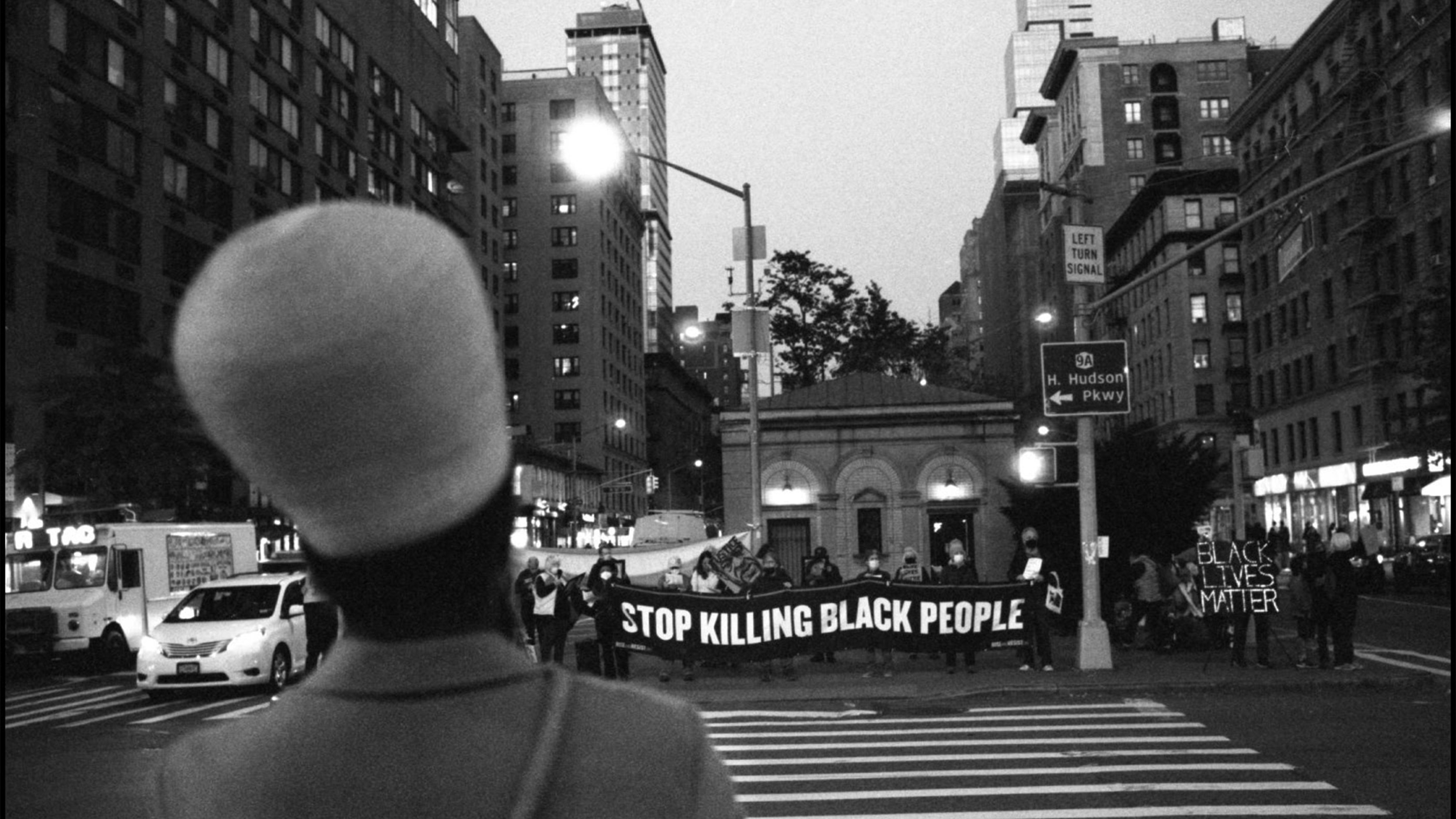 A woman looks towards a Black Lives Matter protest.