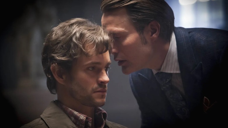 Hannibal Lecter whispering in the ear of Will Graham