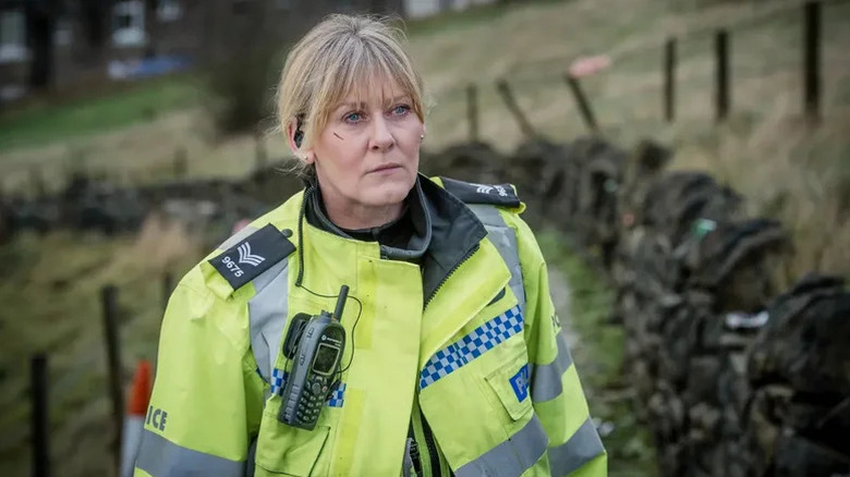 Sarah Lancashire as Catherine Cawood in bright green police uniform in Happy Valley