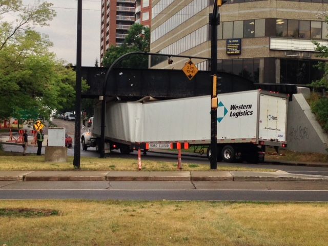 A semi-truck doesn’t make it through the 3.2 metre clearance at the west entrance of Edmonton’s High Level bridge, June 30, 2015.